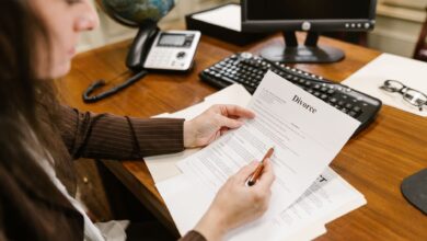 A lawyer examines divorce documents at a desk in a law office setting, emphasizing professionalism.