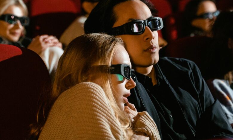 A couple immersed in a 3D movie experience at the cinema, enjoying a thrilling film.