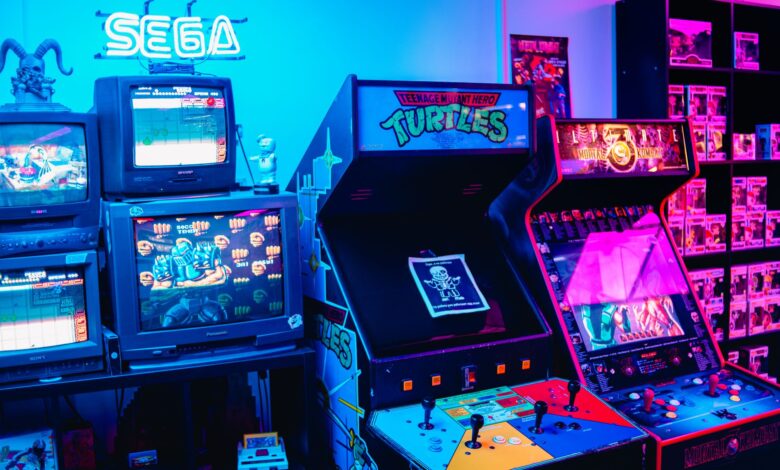 A vibrant retro arcade room featuring classic gaming machines and colorful neon lighting.