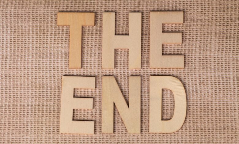 Wooden letters arranged to spell 'The End' on a burlap background.
