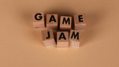 Wooden blocks spelling 'GAME JAM' on a plain brown surface. Perfect for gaming concepts.