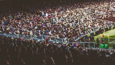 A crowded soccer stadium packed with enthusiastic fans during a match.
