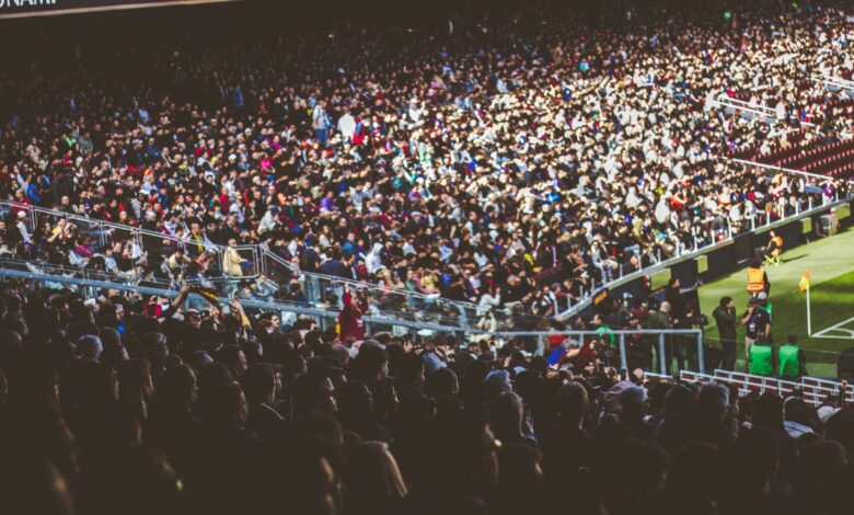 A crowded soccer stadium packed with enthusiastic fans during a match.