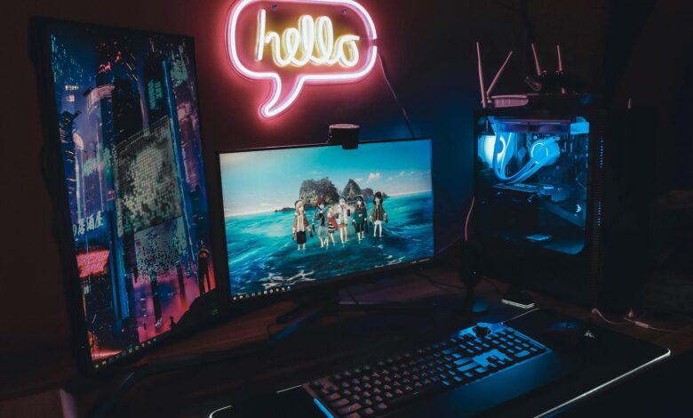 A sleek gaming setup with neon 'hello' sign, dual monitors, and illuminated PC for a futuristic vibe.