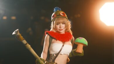 Female cosplayer in vibrant costume holding a toy prop, showcasing charismatic character portrayal.
