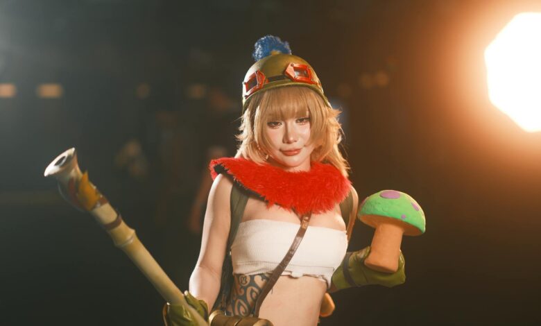 Female cosplayer in vibrant costume holding a toy prop, showcasing charismatic character portrayal.