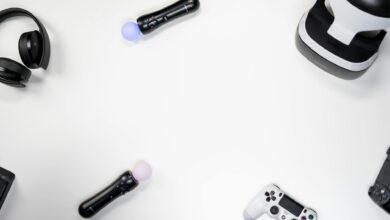 Flat lay of gaming accessories including headset, controller, VR headset on white background.