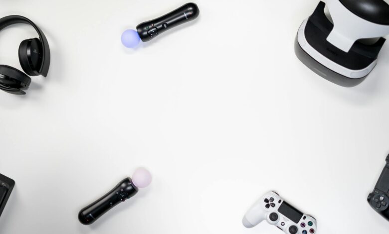 Flat lay of gaming accessories including headset, controller, VR headset on white background.