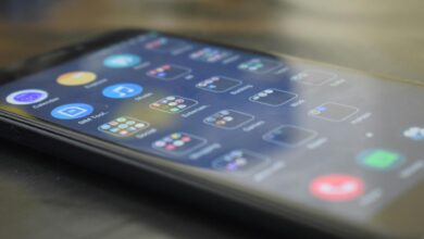 Close-up shot of a smartphone screen showing various app icons, indicating digital technology use.