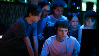 Group of diverse teenagers gaming together indoors, intense and focused.
