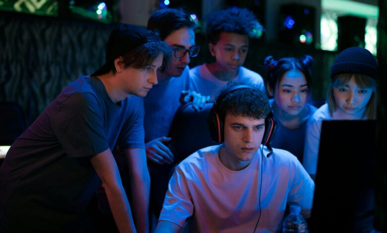 Group of diverse teenagers gaming together indoors, intense and focused.
