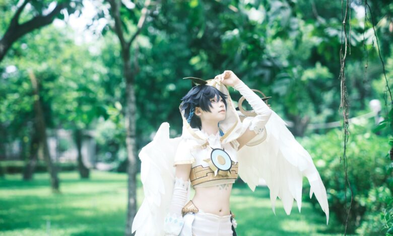 Cosplayer with wings in a vibrant green park environment.