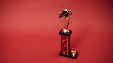 Golden trophy standing on a vibrant red background, symbolizing success and achievement.