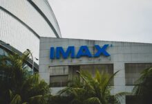 Exterior view of IMAX Theatre in Pasay City, Philippines with palm trees.