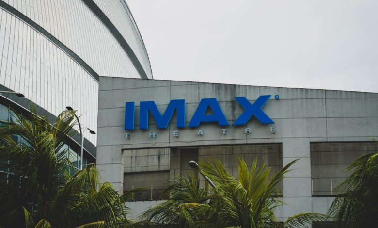 Exterior view of IMAX Theatre in Pasay City, Philippines with palm trees.