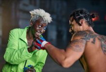 Two men engage in a friendly martial arts practice in an urban setting, showcasing vibrant personalities.