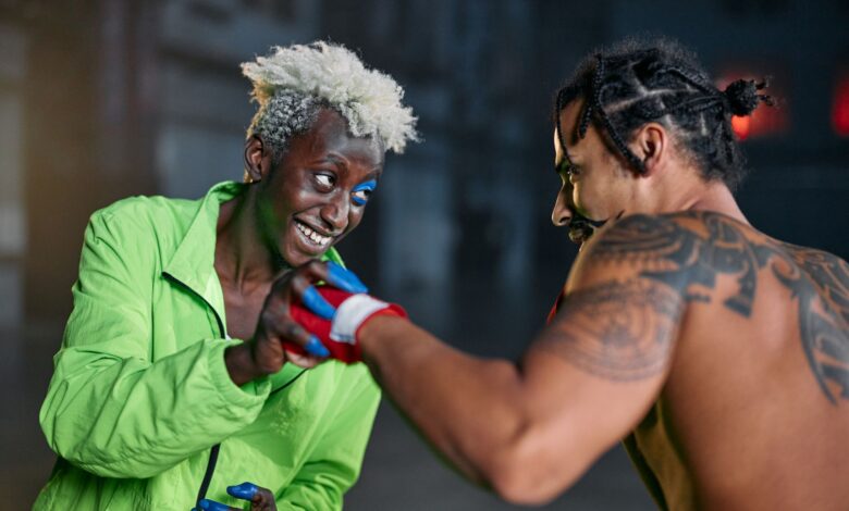 Two men engage in a friendly martial arts practice in an urban setting, showcasing vibrant personalities.