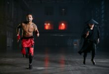 Two men in cosplay costumes running indoors, capturing a dramatic and intense scene.