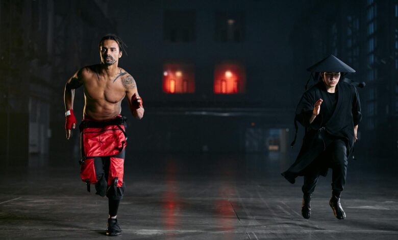 Two men in cosplay costumes running indoors, capturing a dramatic and intense scene.