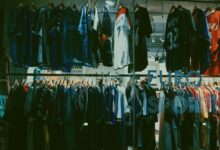 A variety of football jerseys on display in a Tokyo clothing store, highlighting a vibrant shopping scene.