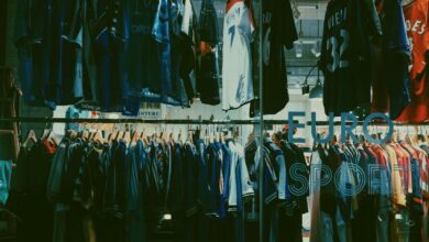 A variety of football jerseys on display in a Tokyo clothing store, highlighting a vibrant shopping scene.