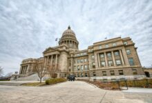 Majestic view of the Idaho State Capitol with its iconic dome under a cloudy sky.