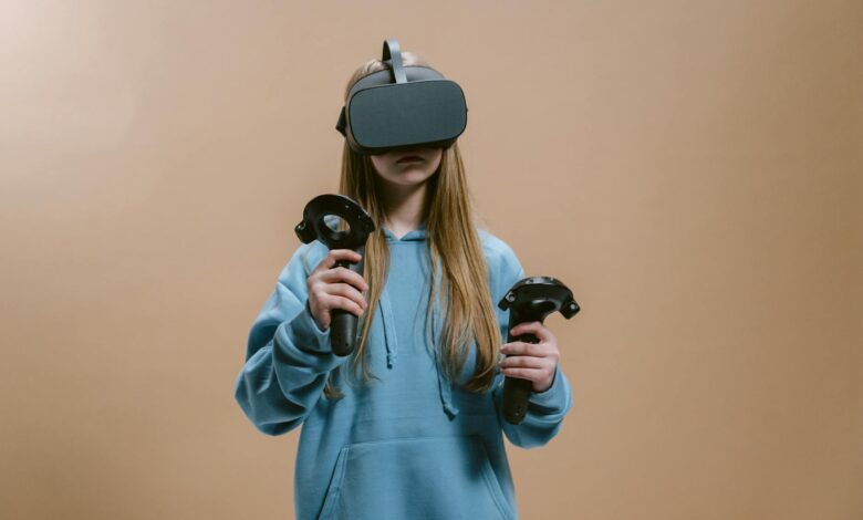 Woman using virtual reality headset with controllers indoors.