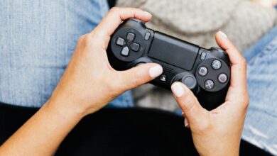 Person holding a video game controller, ideal for leisure and gaming themes.