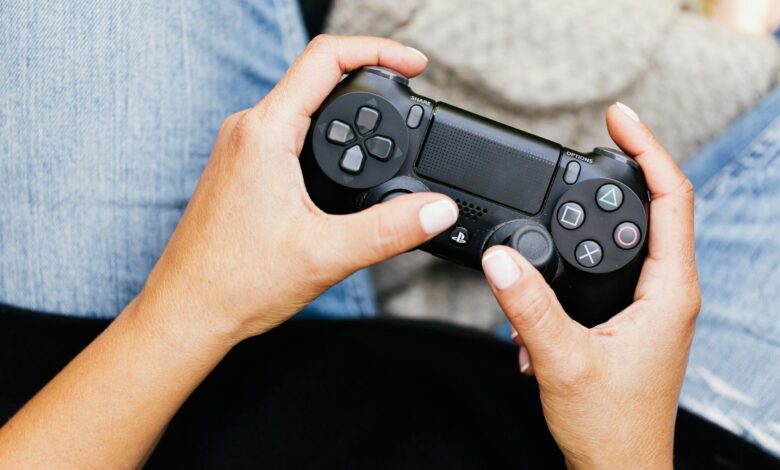 Person holding a video game controller, ideal for leisure and gaming themes.