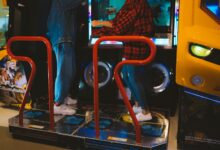 Adults having fun on a dance arcade game indoors. Vibrant, recreational, gaming fun.