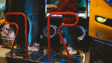Adults having fun on a dance arcade game indoors. Vibrant, recreational, gaming fun.