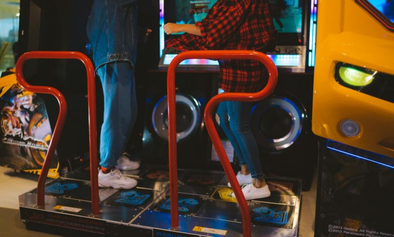 Adults having fun on a dance arcade game indoors. Vibrant, recreational, gaming fun.