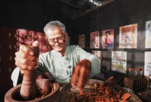 An elderly man in a traditional setting preparing herbs for Chinese medicine.