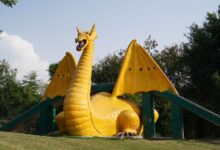 A colorful dragon sculpture situated in a scenic park in Panchkula, India.