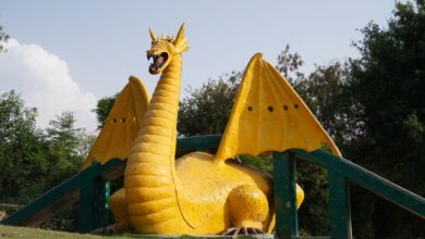 A colorful dragon sculpture situated in a scenic park in Panchkula, India.