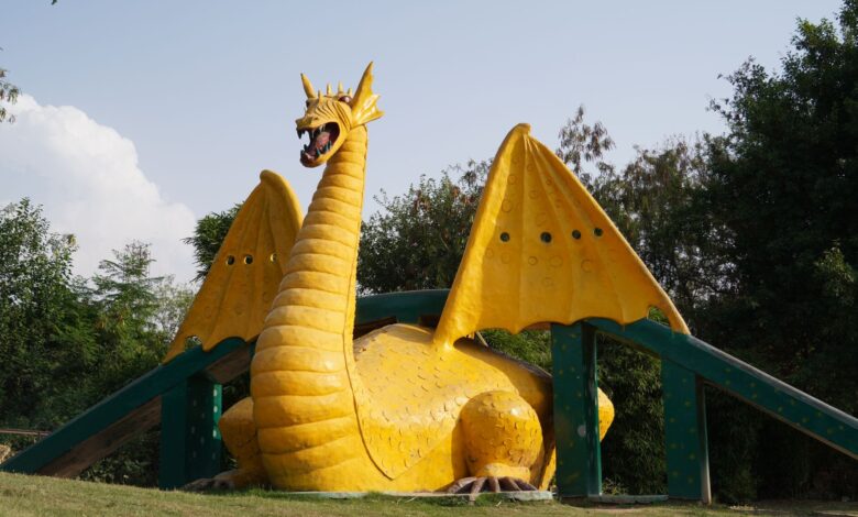 A colorful dragon sculpture situated in a scenic park in Panchkula, India.
