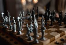 Detailed close-up of metallic chess pieces on a wooden board, showcasing a strategic game in progress.