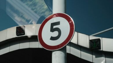 Close-up of a speed limit sign on a street pole in an urban setting.