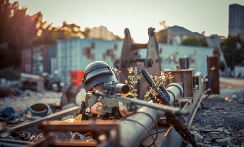 Person with helmet aiming toy gun in urban setting. Conceptual scene with dramatic effect.
