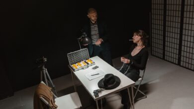 A tense indoor interrogation scene depicting a suspect and law enforcement setup.