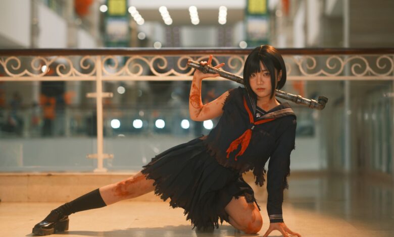 Cosplayer in dynamic pose with weapon in a modern indoor setting, showcasing intricate costume details.