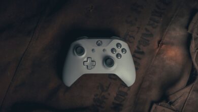 Top view of a gaming controller on rustic fabric, evoking a vintage gaming vibe.