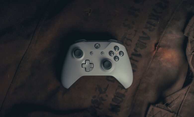 Top view of a gaming controller on rustic fabric, evoking a vintage gaming vibe.