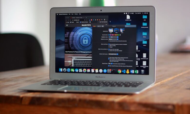 Open MacBook Air with apps and web browser on screen, placed on a wooden table indoors.