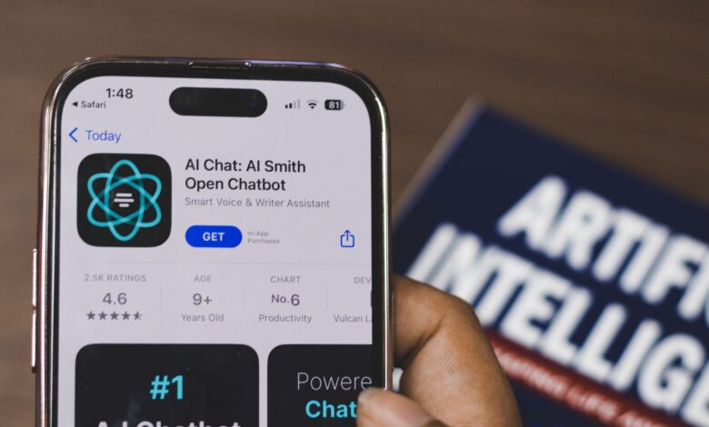 Hand holding a smartphone with AI chatbot app, emphasizing artificial intelligence and technology.