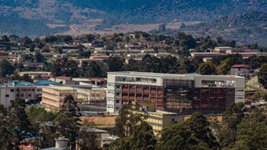 Aerial view of Manzini, Eswatini, showcasing urban development amidst rolling hills.