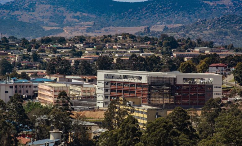 Aerial view of Manzini, Eswatini, showcasing urban development amidst rolling hills.