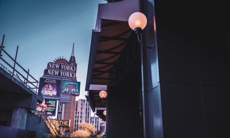 Captivating shot of the New York-New York sign in Las Vegas at twilight, featuring glowing lights and urban architecture.