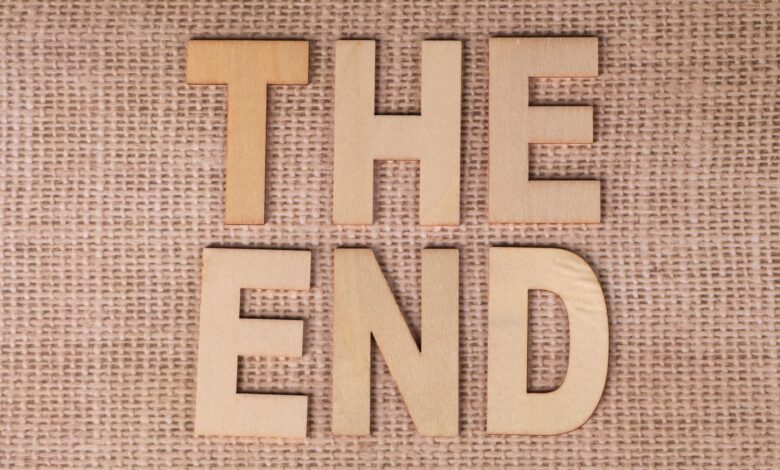 Wooden letters arranged to spell 'The End' on a burlap background.