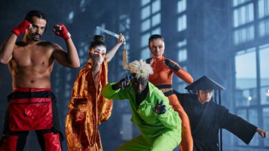 A group of diverse cosplayers striking dynamic poses indoors, showcasing various character styles.